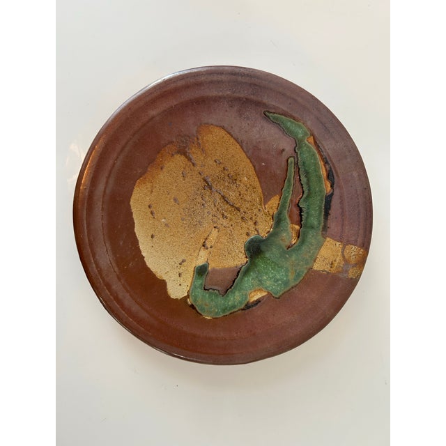 Crafted with an artist's touch, this 9.25" plate is a testament to the timeless appeal of handthrown ceramics. Glazes...