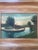 A charming early 20th century signed oil painting on board, depicting a peaceful river landscape with swans gliding across...