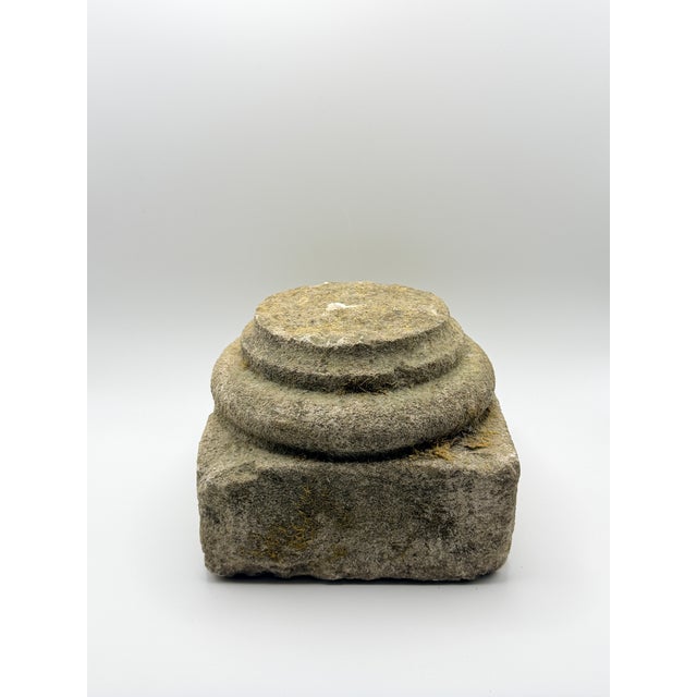 An authentic mid-19th century hand-carved stone architectural plinth featuring a square base supporting a beautifully...