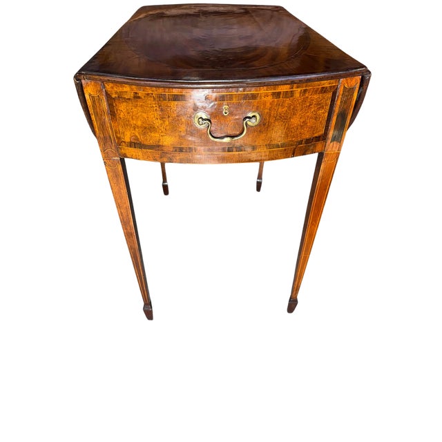 Elegant 19th century English Pembroke table crafted in richly figured mahogany, featuring a beautifully bookmatched top...