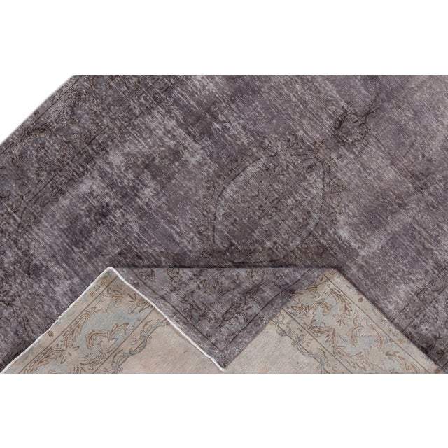 Beautiful vintage Persian distressed hand-knotted wool rug with a gray field. This piece has brown accents in a medallion...