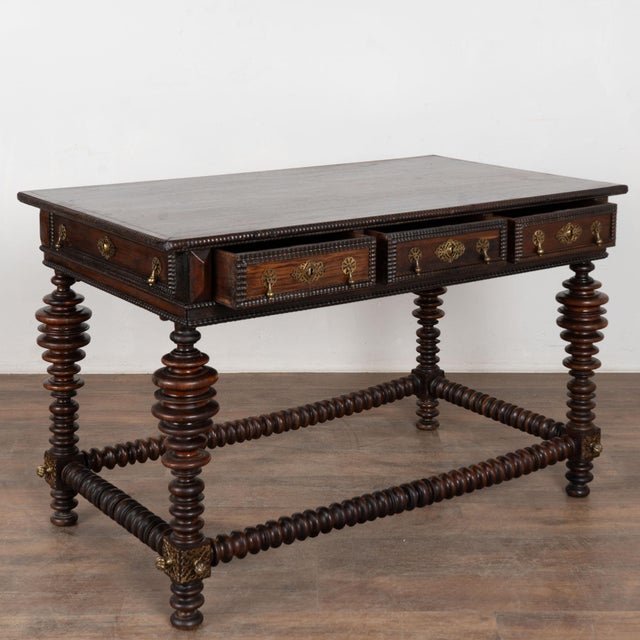 Late 18th century Portuguese console table. Crafted in chestnut wood, the table features highly turned legs on a trestle...