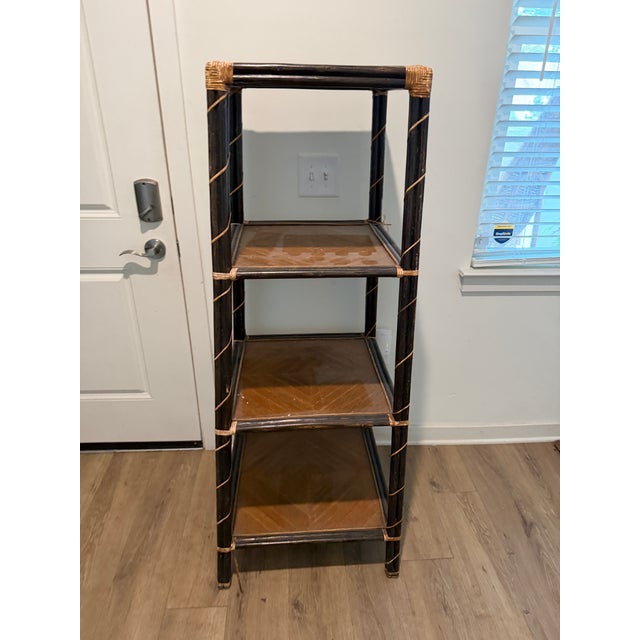 Vintage three-tier rattan and wood étagère featuring a dark finish, woven cane accents, and geometric wood-grain shelves....