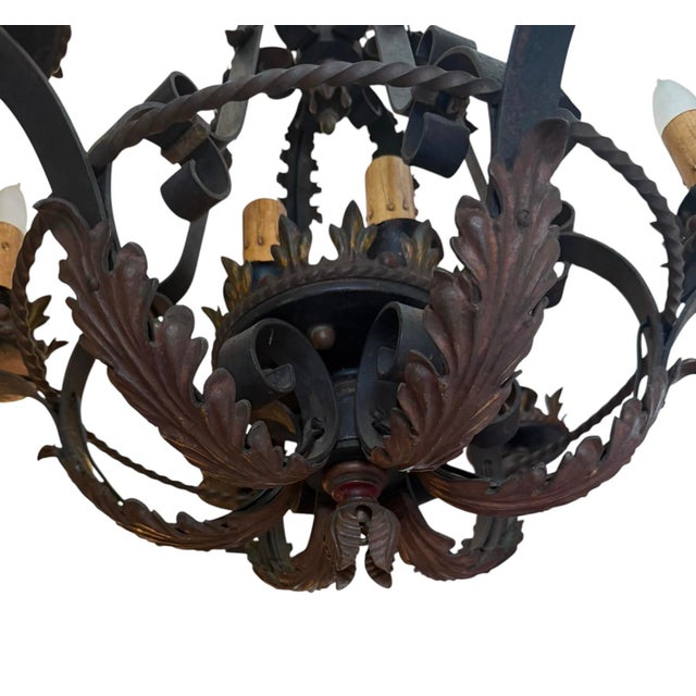 This 1920’s wrought iron chandelier has 9 lights and incredibly intricate iron work. Wrought iron has original polychrome...