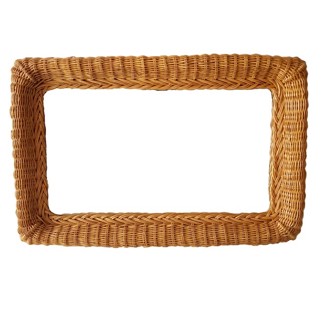 Beautiful rectangular wall mirror with a woven rattan frame from the 1960s. The wall mirror consists of a wide woven...