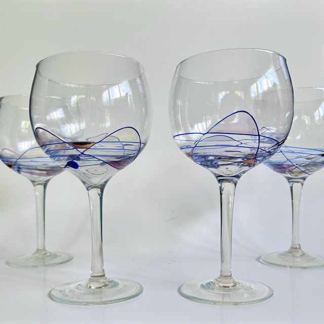 A striking set of four vintage balloon wine glasses from Artland’s sought-after “Helios” collection, featuring a vibrant...