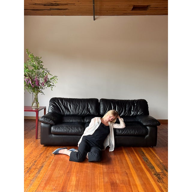 A modern black "draping leather" sofa by Roche Bobois. Mid-Century Modern or Postmodern Italian style. Characterized by...