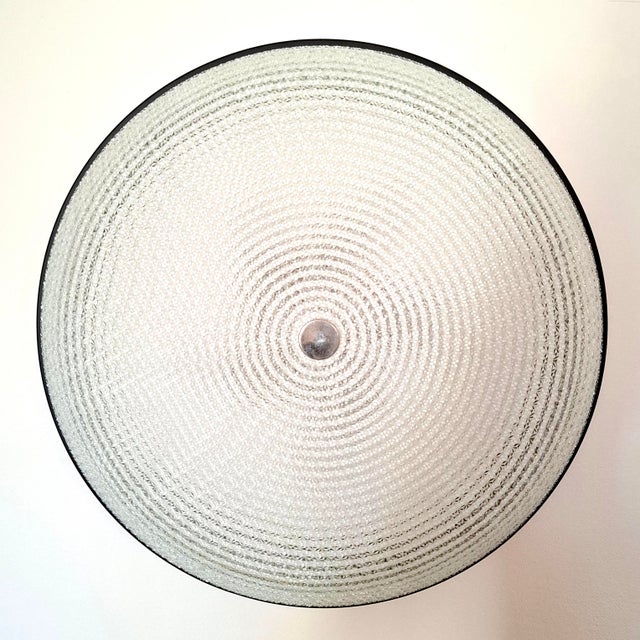 This exceptional ceiling/wall light captivates with its heavy, high-quality textured glass featuring a concentric cut. The...