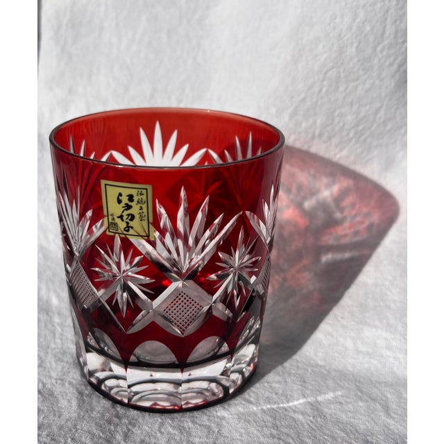 Kaleidoscopic light-catching single red lowball whiskey glass. Matching blue glass listed separately. Edo Kiriko glass was...