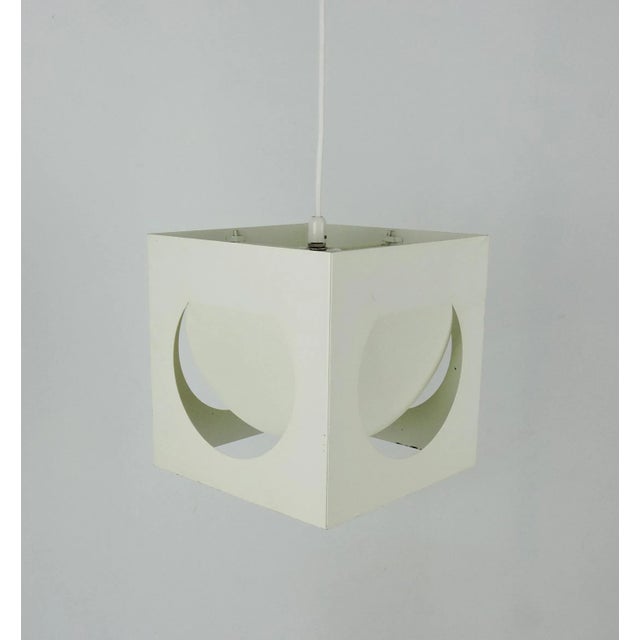 A 1960s Finnish square pendant light featuring cut out shapes. This piece is attributed to the mentioned designer/maker....