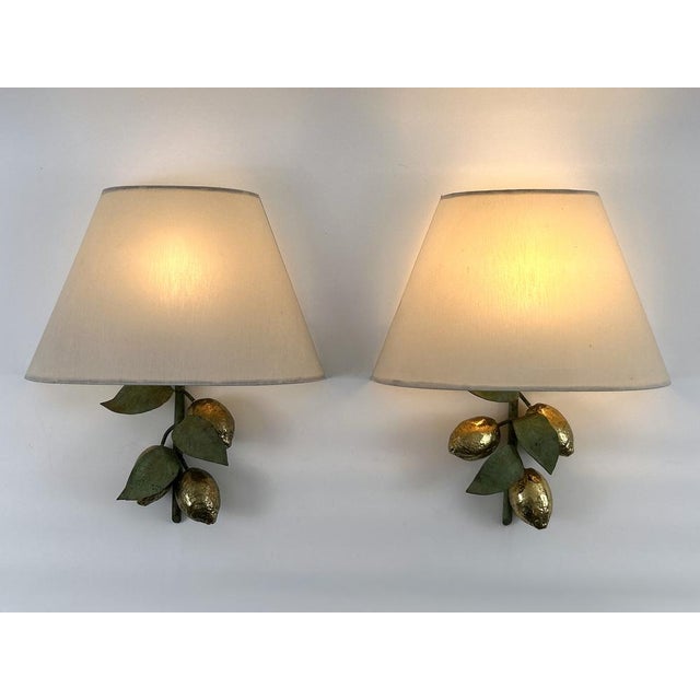 Set of two exceptional, large, elegant and highly decorative mid-century modern brass lemon sconces or wall fixtures....