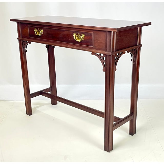 Chippendale-style mahogany console table by renowned American maker Councill Craftsmen. This table features a beautiful...