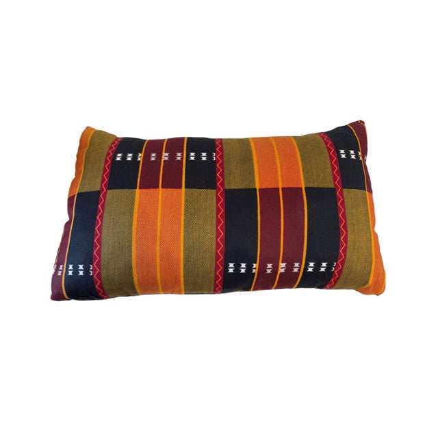 The African Kente cotton Cloth Pillow is a unique and stylish addition to any home decor, featuring a lumbar shape with...