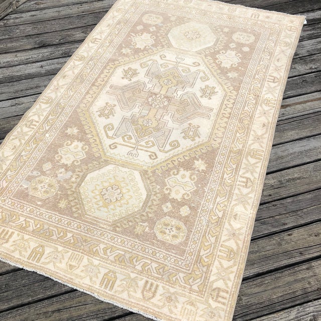 A Neutral Vintage Kazak Rug with Timeless Geometric Design This beautiful vintage Kazak rug was handwoven approximately 80...