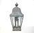 An antique, 19th-century galvanized tin metal outdoor lantern in the traditional carriage light shape, with a round finial...
