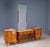 A distinctive mid-century dressing table from Czechoslovakia, featuring richly figured burl veneer, a large central...