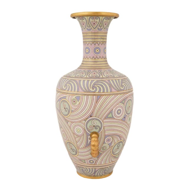 A Japanese enamel vase. The vase has an urn shape with a lon narrow neck with a fluted mouth. The exterior of the vase is...