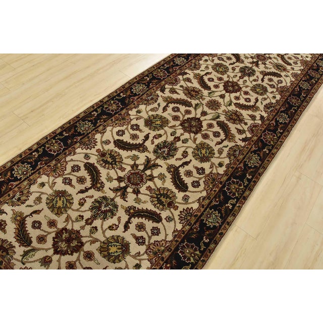 An authentic Agra runner hand-knotted with fine wool on a cotton foundation. This rug features a botanical design set...