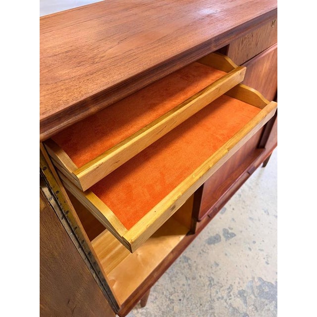 This teak highboard is an impressive testament to Danish craftsmanship from the mid-century era. Made in Denmark, it...