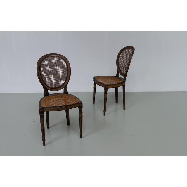 French Louis XVI Style Cane Side Chairs, 1880s. Set of 2. Gorgeous pair of hand carved side chairs with original woven...