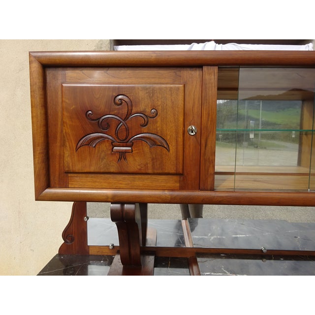 Large and attractive solid walnut sideboard with moustache-shaped legs and simple, straight curves. Lower section:...