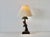 Vintage Majolica-inspired plaster hand-painted tropical table lamp featuring a red parrot perched on a palm tree-style...