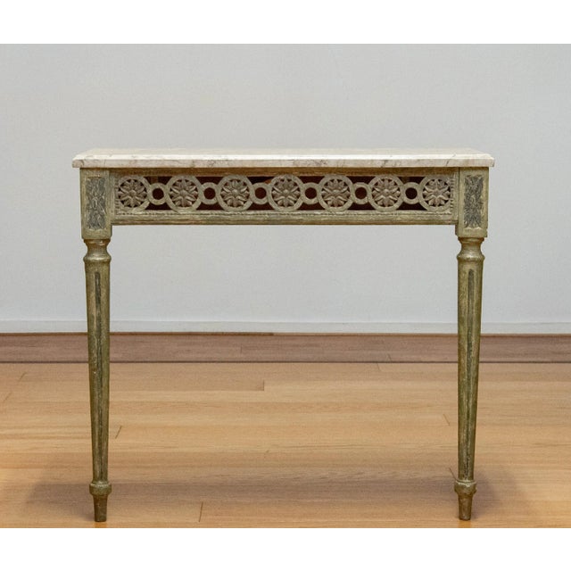 A finely handcrafted swedish louis xvi console table from the early 18th century. Made of oak, the table features a...