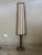 This floor lamp or small lamp features a rattan frame and a rattan and paper shade. It is fully functional (B22 bulb not...