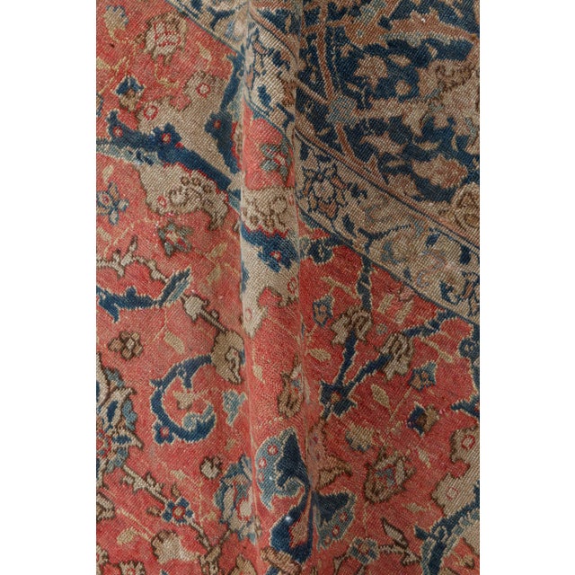 A fine example from our collection of early 20th century Persian Tabriz rugs, the rich salmon field with an allover...