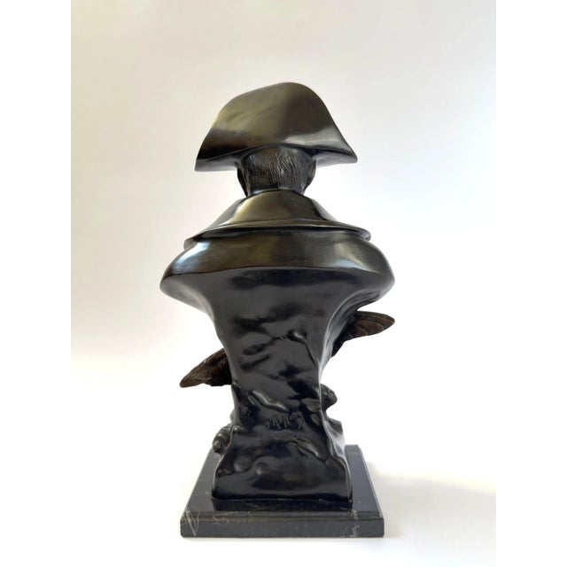 Finely cast bronze bust of Napoleon Bonaparte wearing his iconic bicorne hat, modeled with expressive detail and mounted...