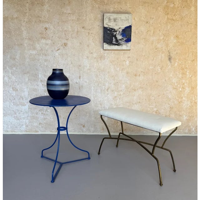 A striking pair of recently made Spanish mid-century modern style gilt iron benches, distinguished by their graceful...