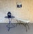 A striking pair of recently made Spanish mid-century modern style gilt iron benches, distinguished by their graceful...