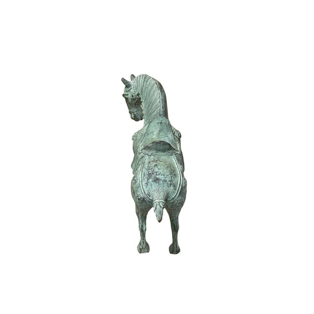 Behold the exquisite Bronze Saddled Horse of the Tang Dynasty Style, a masterpiece of ancient Chinese artistry that...