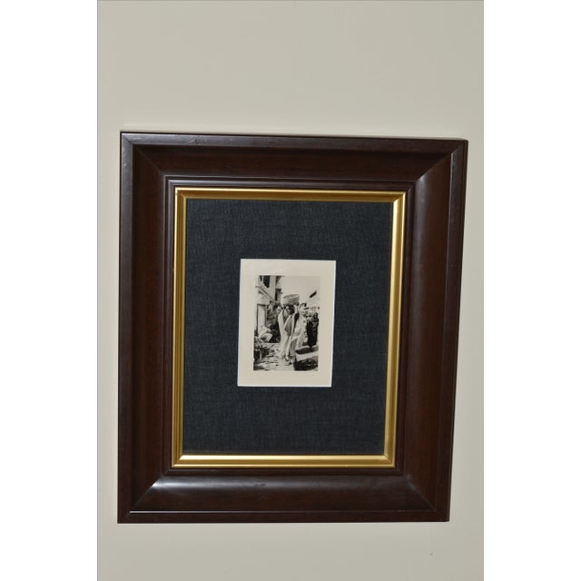 Original vintage black and white with sepia tone photograph with margins. African woman with basket in market scene. Ready...