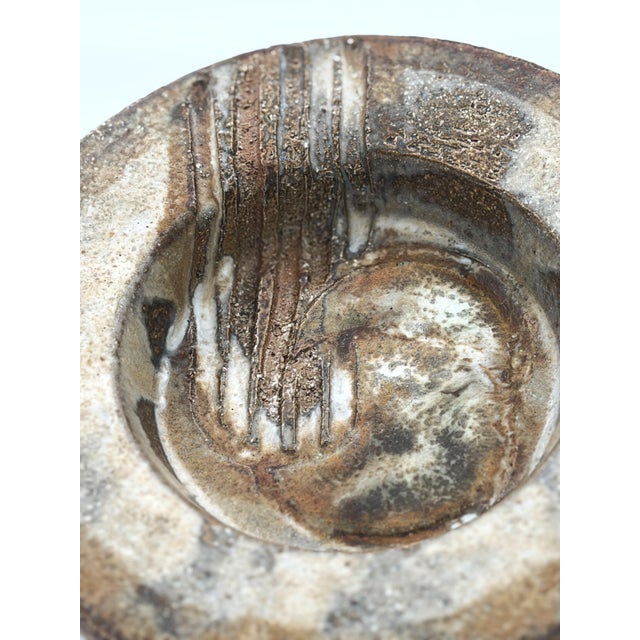 A beautiful Mid-Century Danish studio pottery bowl designed by Aksel Larsen for Axella during the 1960s. Featuring a warm...