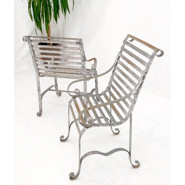 Heavy antique wrought iron outdoor chairs his & hers. Metal ribs slots and rivets design, good looking form.