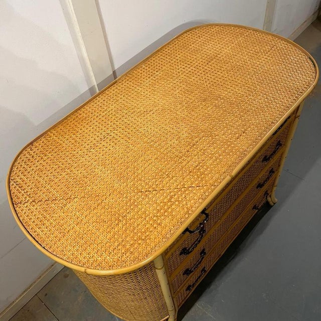 Bamboo and cane oval chest with 4 drawers, top drawer is not as deep as the other 3 Cane covered drawers The drawers have...