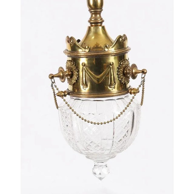 An exceptional antique pair of Edwardian Neo-classical brass and cut-crystal ceiling lights, circa 1900 in date. These...