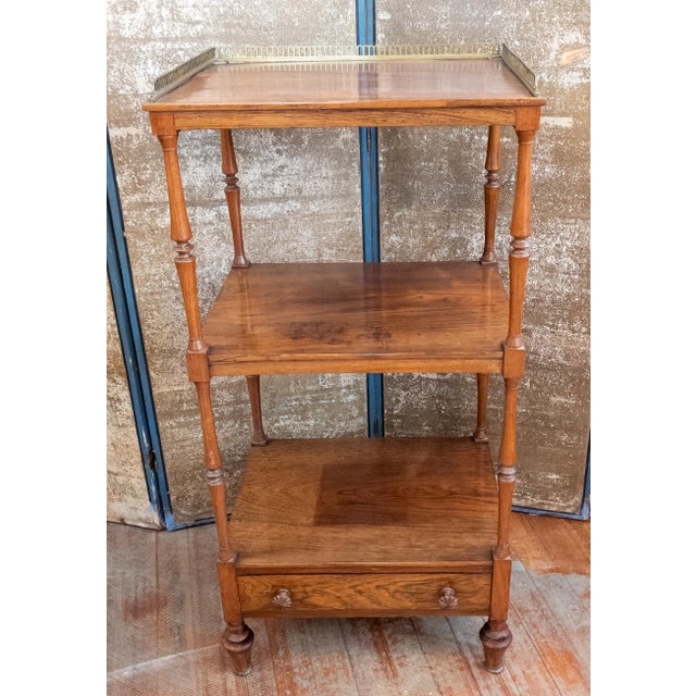We are selling this gorgeous English Regency or Anglo-English Rosewood Etagere. This etagere has three main shelves, the...