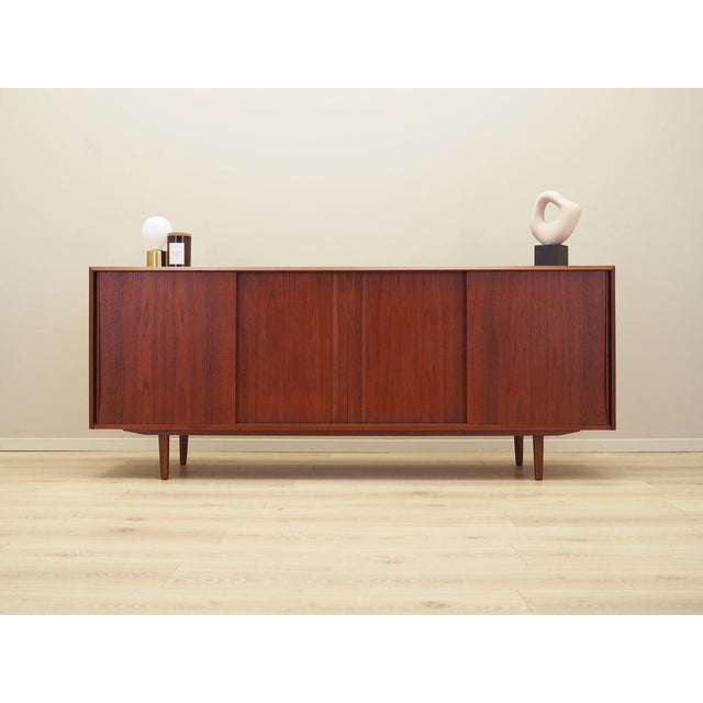The sideboard was made in the 1960s, designed by the well-known Danish designer E.W. Bach. The structure is covered with...