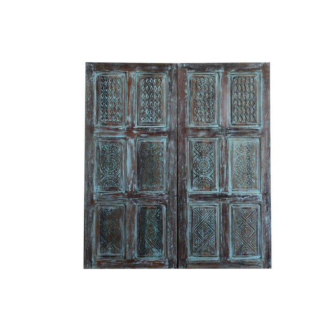 Bring character and charm to your interiors with this distressed blue vintage carved barn door. Handcrafted from solid...