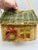 This is a delightful woven wicker basket designed in the shape of a little house — a whimsical and decorative piece. Form...