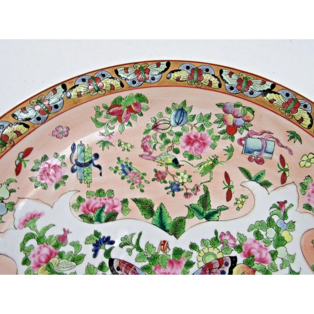 The product is a 19th-century Famille Rose Canton bowl or plate with a delicate butterfly border and intricate insect...