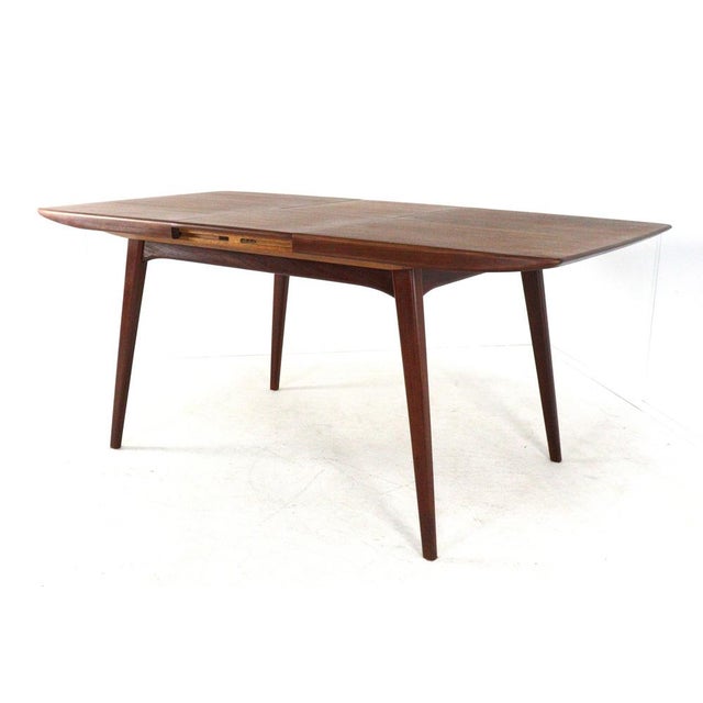 A genuine WéBé dining table with a flip-top leaf, designed by Louis van Teeffelen. This 'Milan' model was—and remains—a...