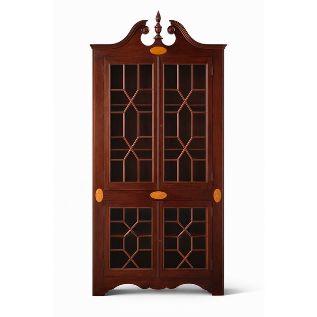 Wonderful mahogany corner cabinet. Beautiful medallion inlays. Broken arch pediment with fluted finial. The doors have a...