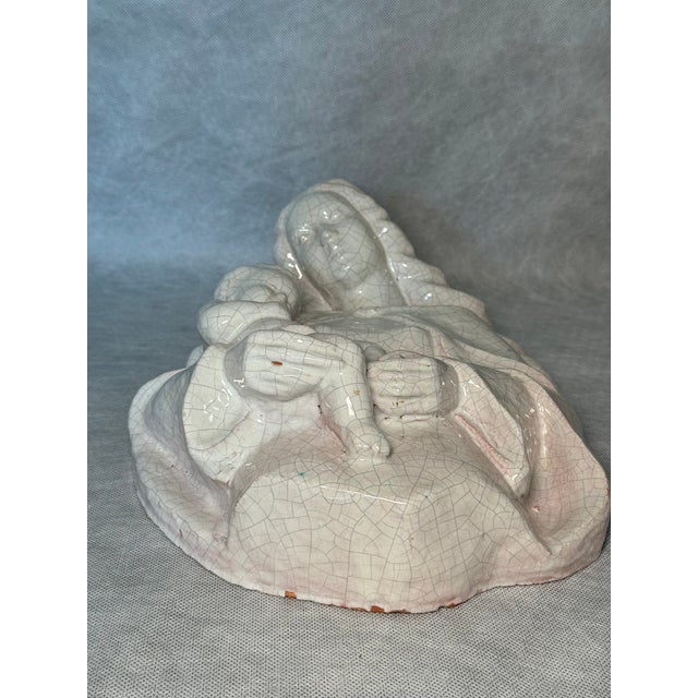 Italian decorative wall relief depicting Madonna and Child, made of terracotta with a light glaze and pronounced crackle...