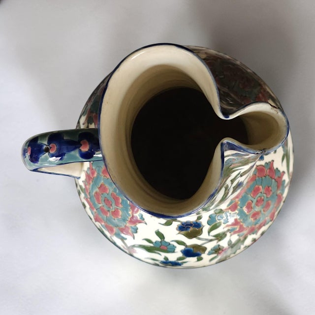 Decorative ceramic pitcher produced by Zsolnay Pécs, Hungary, featuring richly colored Ottoman-inspired floral decoration...