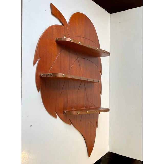 Skillfully crafted wall mounted spice-rack or display-shelf in shape of a giant leaf. The 3 shelves features decor in...