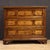 Mid-20th-century Italian chest of drawers. Antique-style furniture carved and inlaid in walnut, maple, and fruitwood, with...