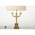 French vintage (early 20th century) Empire-style cast brass table lamp with custom linen shade. This striking fixture...